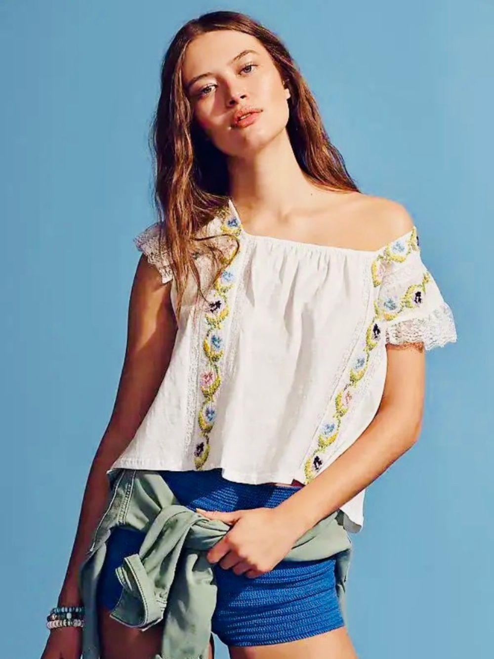 By Anthropologie Cropped Swing Top, featuring colorful floral embroidery, a squa